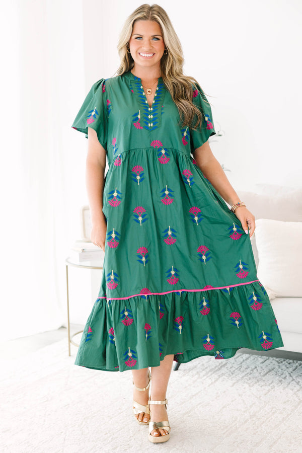 Plus size hunter green midi dress with pink floral embroidery, flowy fit, and tiered ruffle hem.