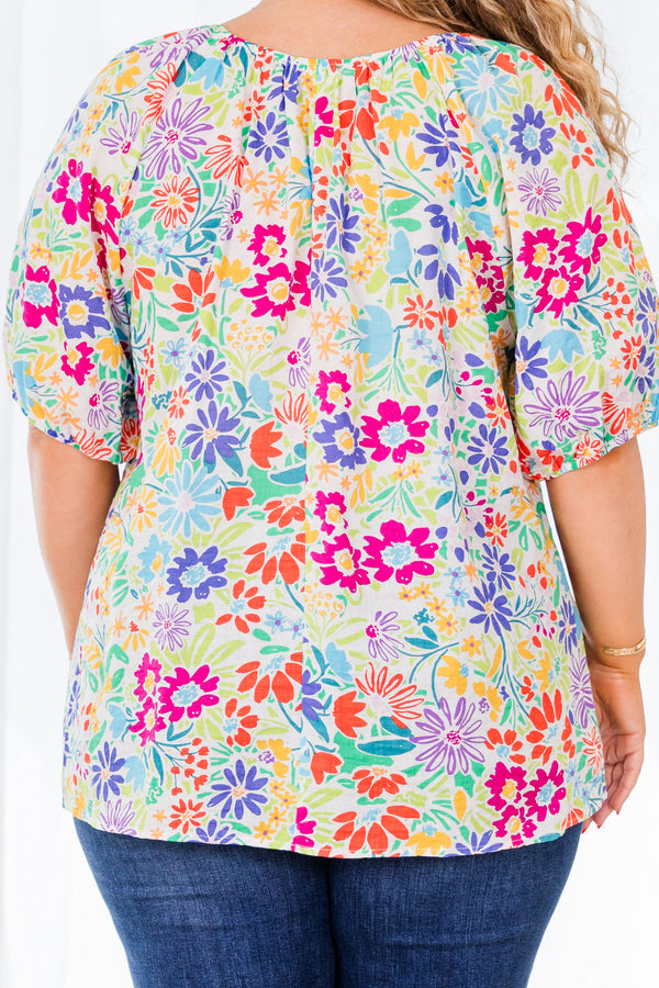 Plus Size multi-colored floral print top with bubble sleeves and a textured fabric.