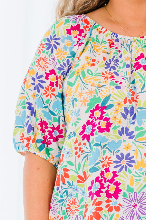 Plus Size multi-colored floral print top with bubble sleeves and a textured fabric.