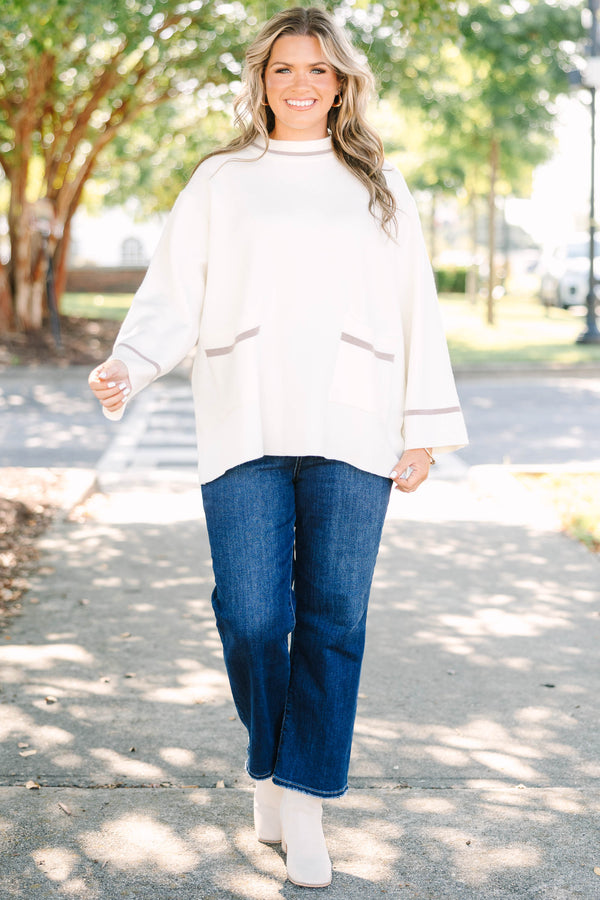 Plus Size ivory oversized sweater with a mock neck, wide sleeves, and tan stripe accents.