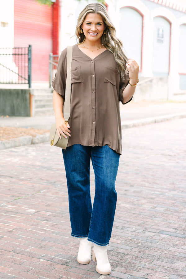 Plus Size brown short sleeve button-down blouse with a v-neckline and front chest pockets.