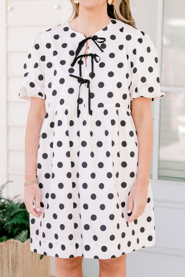 Chic Soul plus size clothing, short-puffed-sleeve white flowy short baby doll dress with black polka dots and black tied bows on the neckline