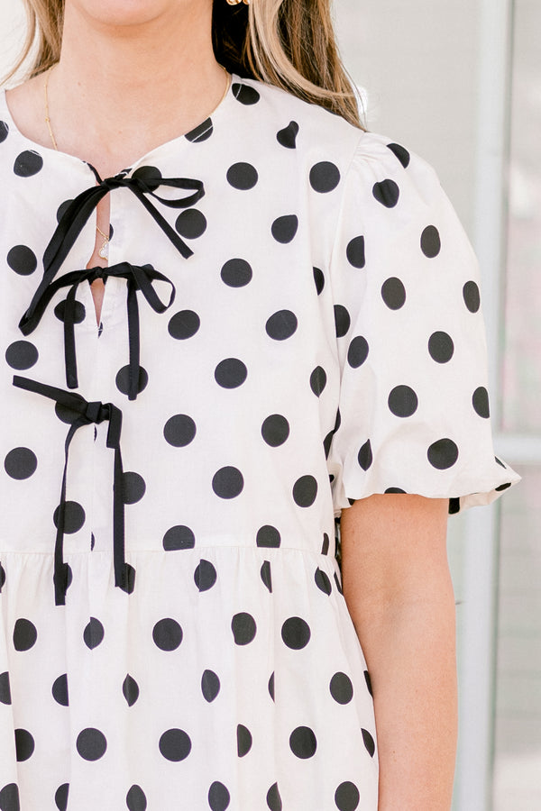 Chic Soul plus size clothing, short-puffed-sleeve white flowy short baby doll dress with black polka dots and black tied bows on the neckline