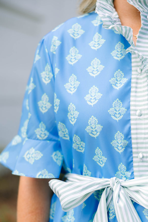 Plus Size blue tiered dress with white floral print, ruffled collar, and striped waist tie.