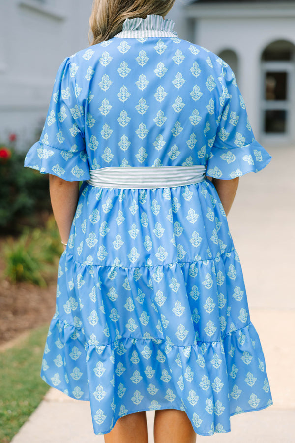 Plus Size blue tiered dress with white floral print, ruffled collar, and striped waist tie.