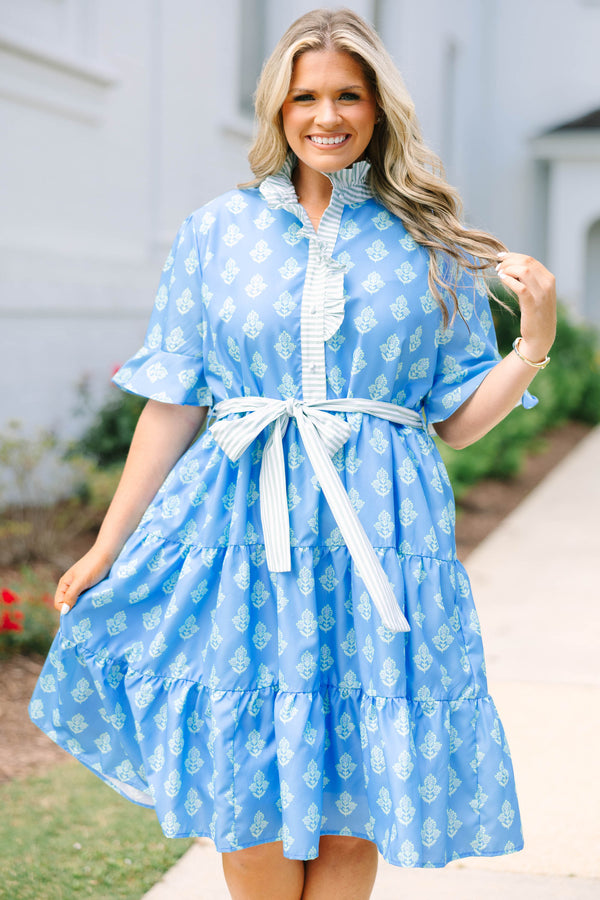 Plus Size blue tiered dress with white floral print, ruffled collar, and striped waist tie.