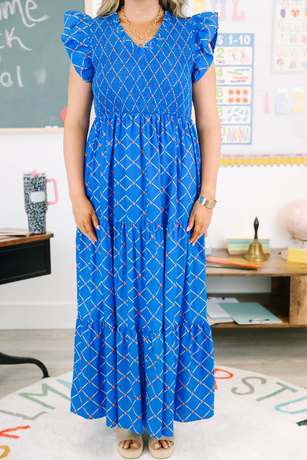 Plus Size blue maxi dress with an apple grid pattern, smocked bodice, and flutter sleeves.