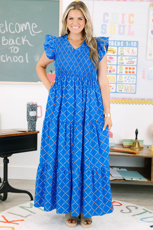 Plus Size blue maxi dress with an apple grid pattern, smocked bodice, and flutter sleeves.