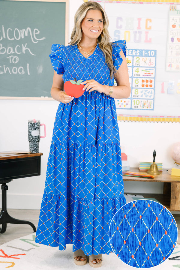 Plus Size blue maxi dress with an apple grid pattern, smocked bodice, and flutter sleeves.