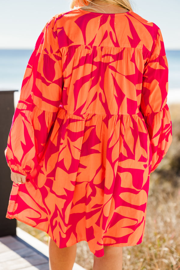 Chic Soul plus size clothing, orange long sleeve mini dress with tiered sleeve detail with v neckline and cuff puff sleeves with large abstract pink print
