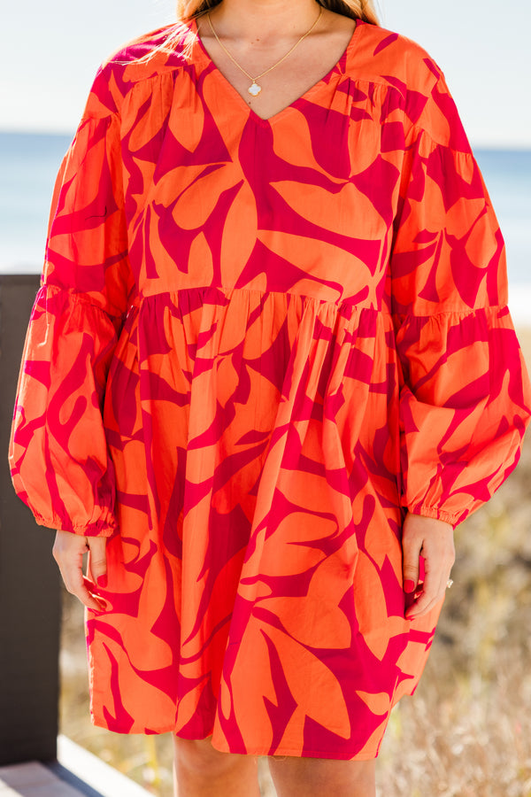 Chic Soul plus size clothing, orange long sleeve mini dress with tiered sleeve detail with v neckline and cuff puff sleeves with large abstract pink print
