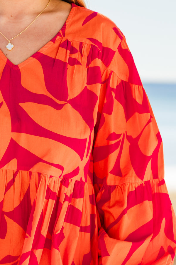 Chic Soul plus size clothing, orange long sleeve mini dress with tiered sleeve detail with v neckline and cuff puff sleeves with large abstract pink print
