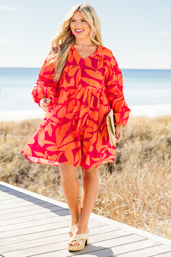 Chic Soul plus size clothing, orange long sleeve mini dress with tiered sleeve detail with v neckline and cuff puff sleeves with large abstract pink print
