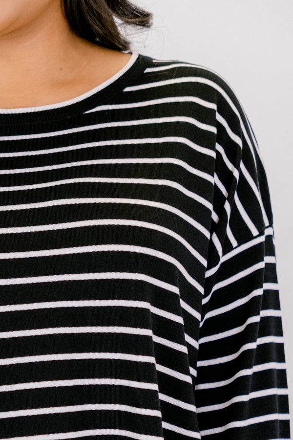 Chic Soul plus size clothing, black long sleeve crew neck top with thin white horizontal stripes and a ruffle hem