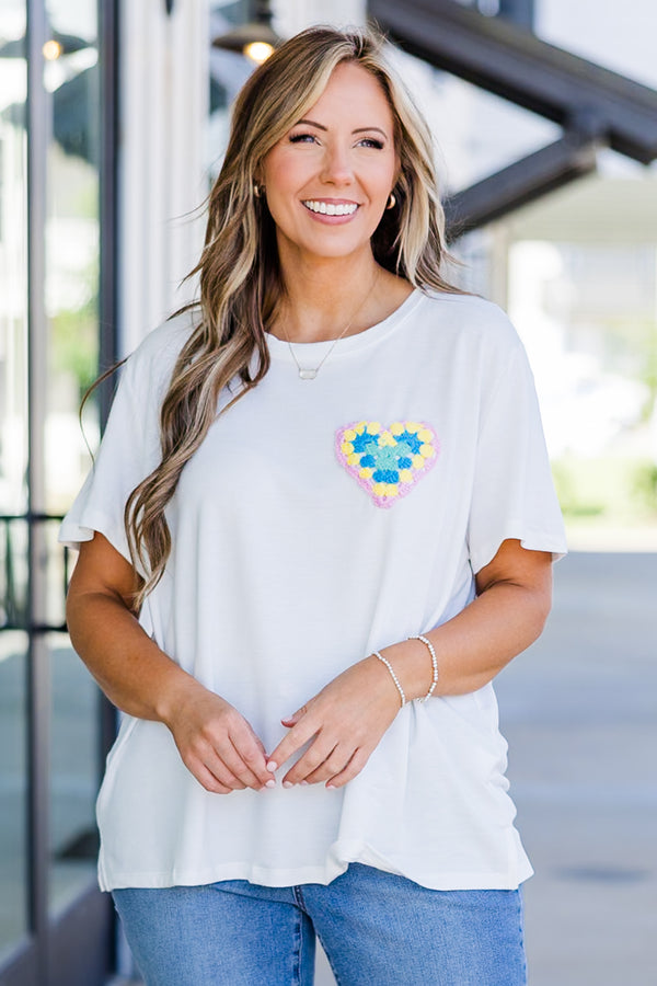 Chic Soul plus size clothing, short-sleeve high-scoop-neckline off-white top with small multi-colored crochet heart on left side of bodice