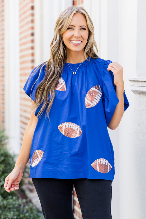 Chic Soul plus size clothing, short-flutter-sleeve blue top with smocked neckline and brown sequined football patches scattered across top 