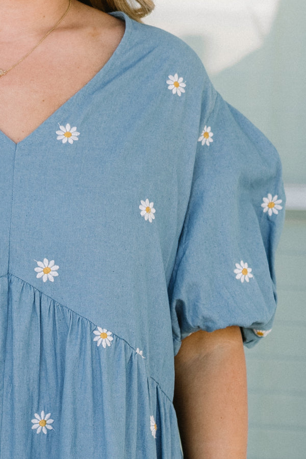 Chic Soul plus size clothing, short-puffed-sleeve denim blue ruffled baby doll top with a v-neckline and a subtle white daisy pattern 