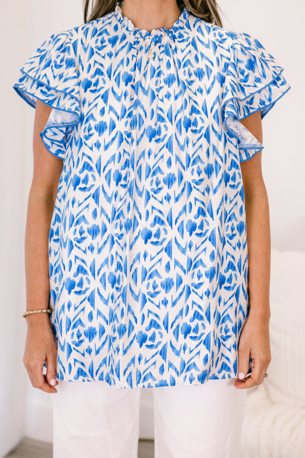 Plus Size blue and white abstract print top with flutter sleeves and a high neckline.