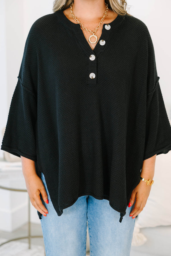 Plus Size black oversized knit top with a button-up henley neckline and three-quarter sleeves.