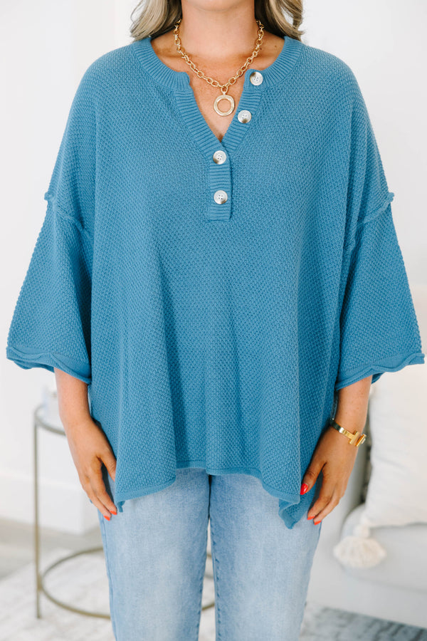 Plus Size blue knitted henley top with a relaxed fit, button neckline, and side slits.