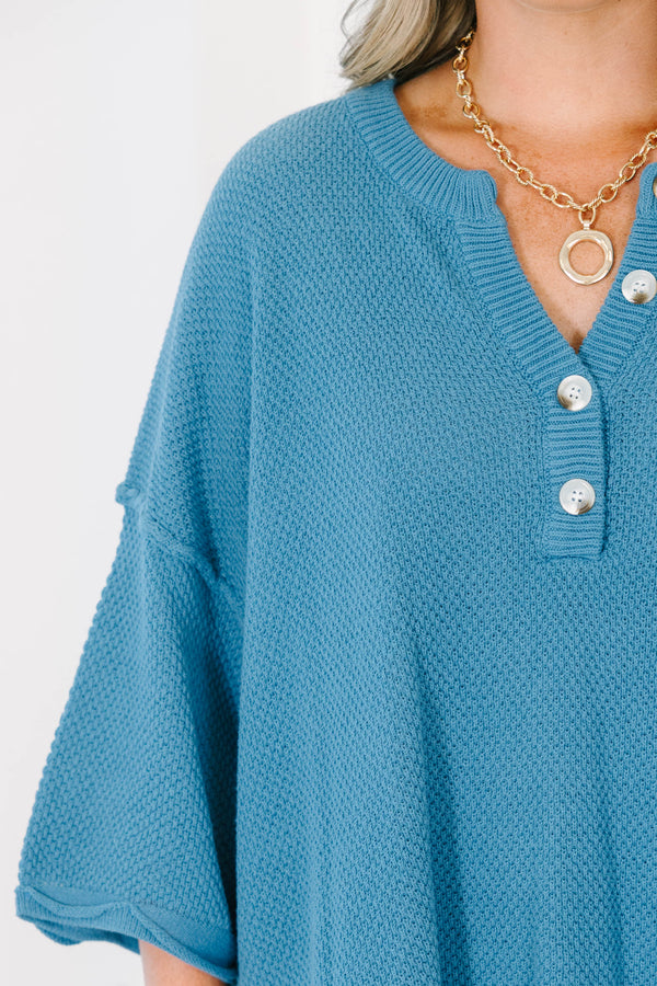 Plus Size blue knitted henley top with a relaxed fit, button neckline, and side slits.