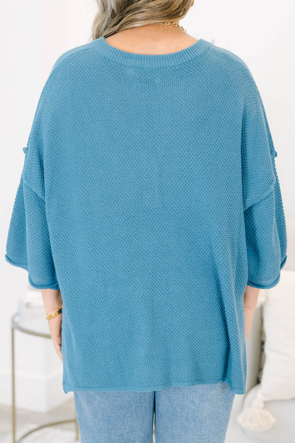 Plus Size blue knitted henley top with a relaxed fit, button neckline, and side slits.