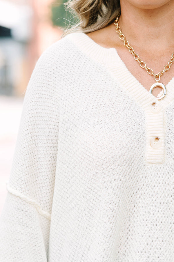 Plus Size cream knitted henley top with a relaxed fit, long sleeves, and button-down neckline.