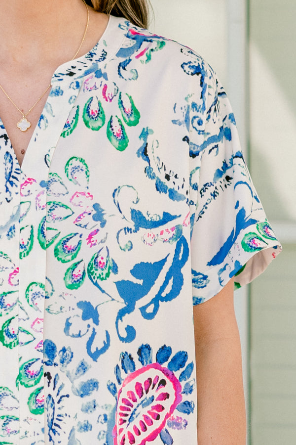 Plus Size short sleeve split v-neck top with a vibrant blue and pink abstract paisley print.