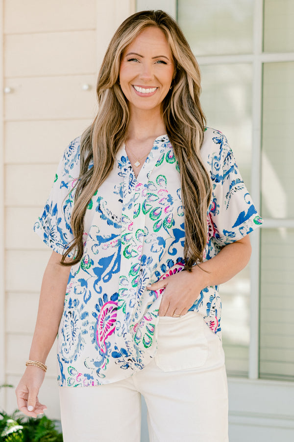 Plus Size short sleeve split v-neck top with a vibrant blue and pink abstract paisley print.