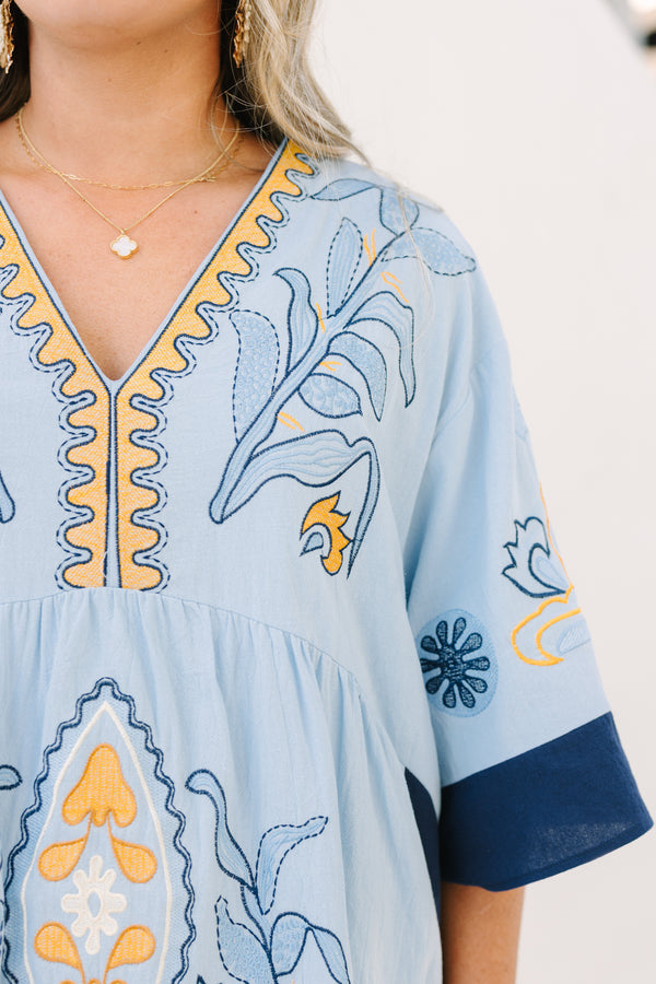 Chic Soul plus size clothing, light blue v neck tunic dress with orange and navy embroidery detailing and navy blocking on the edge of the sleeve and sides of the dress
