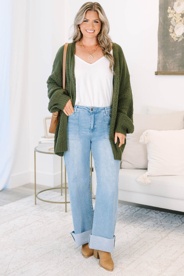 Plus size light wash high-rise wide-leg jeans featuring oversized cuffed hems and patch pockets.