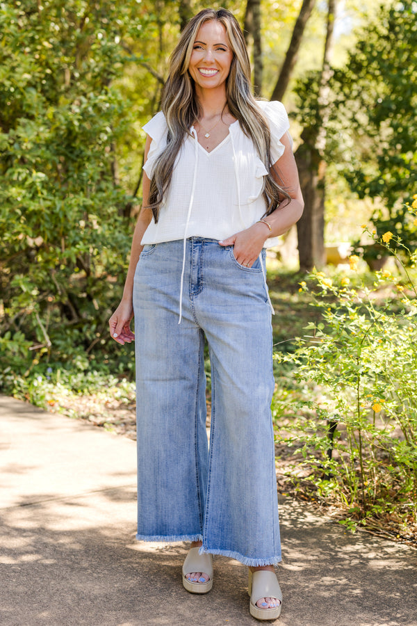 chic soul plus size clothing, Light wash jeans with front pockets and a fringed detail at the end of the pant leg 