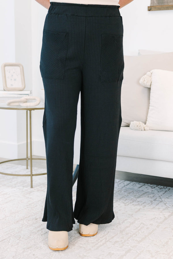 Plus Size black wide-leg ribbed knit pants with an elastic waistband and front patch pockets.