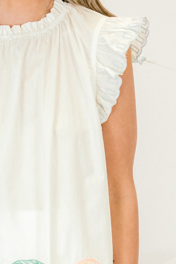 Chic Soul plus size clothing, white top with flutter sleeves and stitching details or fruit and various patterns along the bottom of the top 