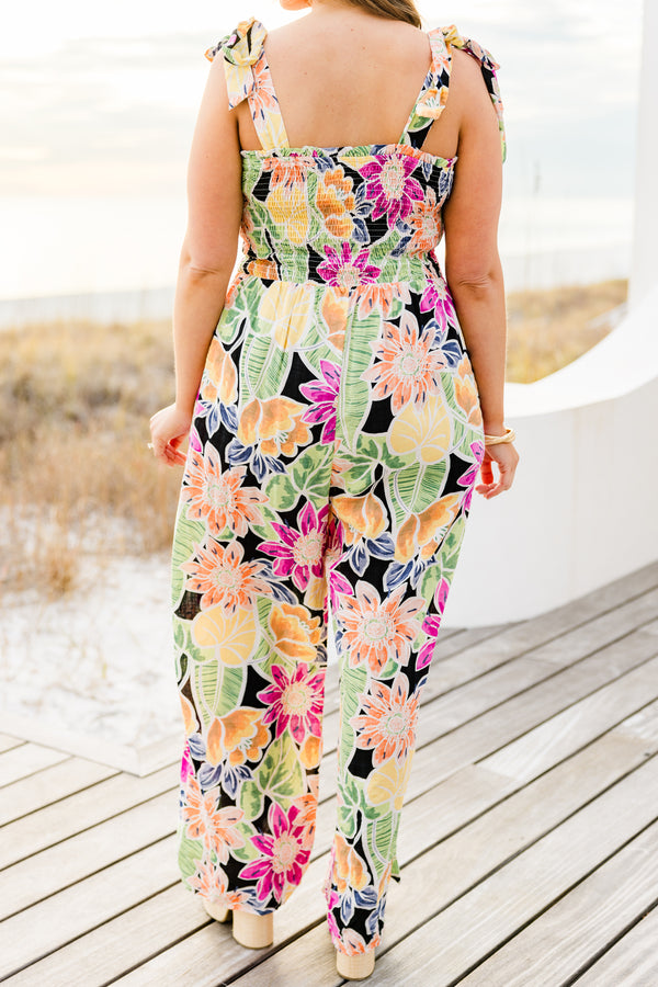 Chic Soul plus size clothing, black sleeveless flowy jumpsuit with a smocked bodice and tied straps with a multi-colored floral pattern