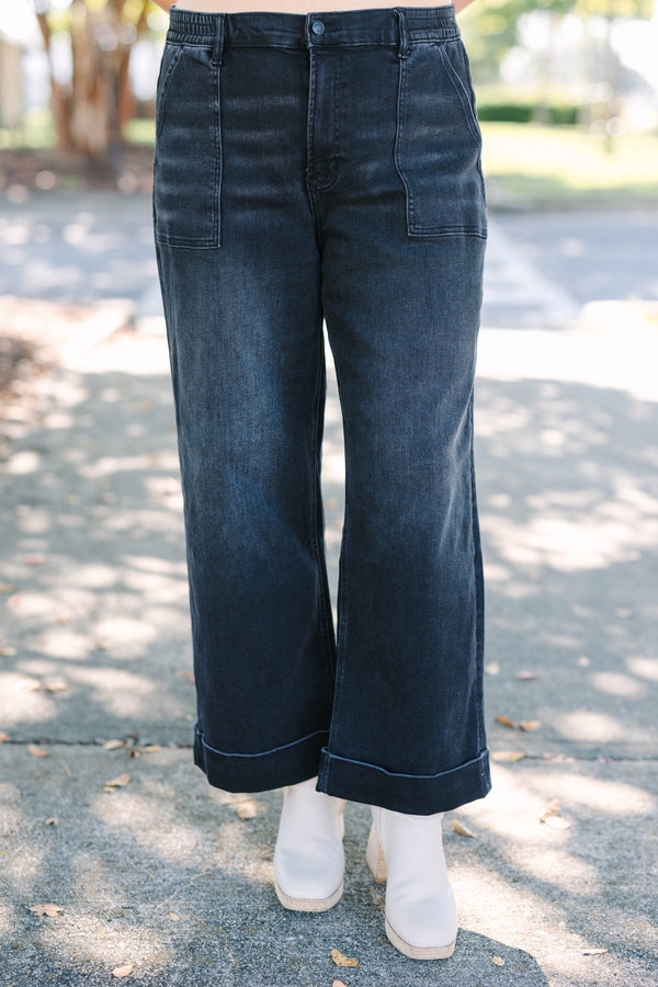 Plus Size black wide-leg jeggings with front patch pockets and cuffed hems.