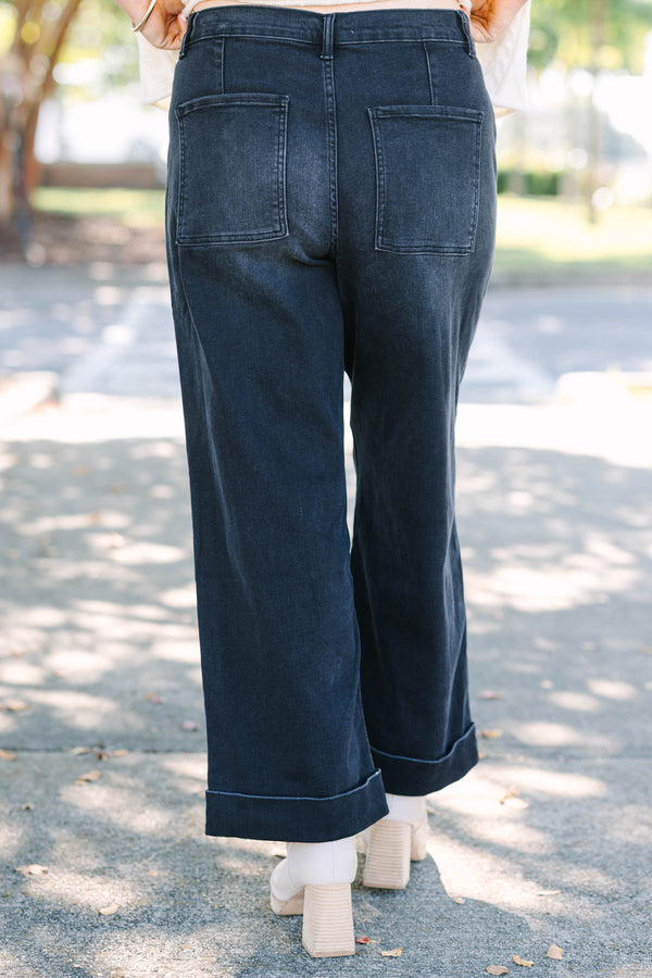 Plus Size black wide-leg jeggings with front patch pockets and cuffed hems.