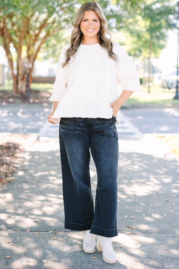 Plus Size black wide-leg jeggings with front patch pockets and cuffed hems.