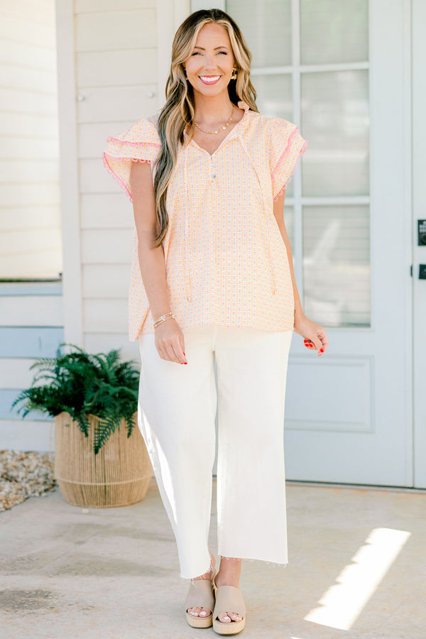 Plus Size pink ditsy floral top with flutter sleeves, tassel ties, and functional buttons.