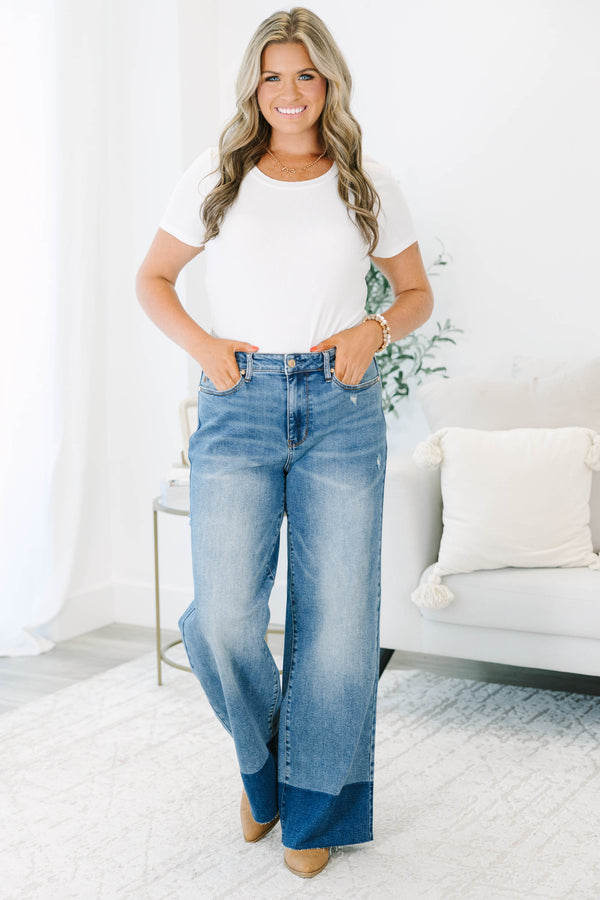 Plus Size high-waisted wide leg jeans in a medium wash with a dark wash blocked raw hem.