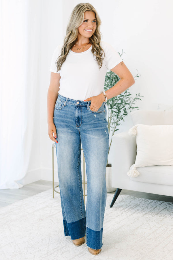 Plus Size high-waisted wide leg jeans in a medium wash with a dark wash blocked raw hem.