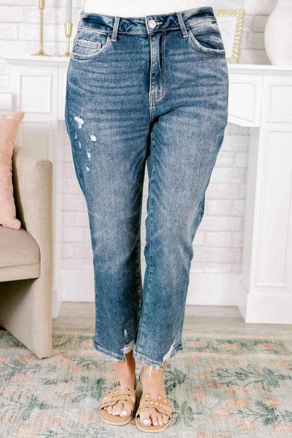 Chic Soul plus size clothing, medium wash denim jeans with distressed holes on the right pant leg and distressing and frayed hems