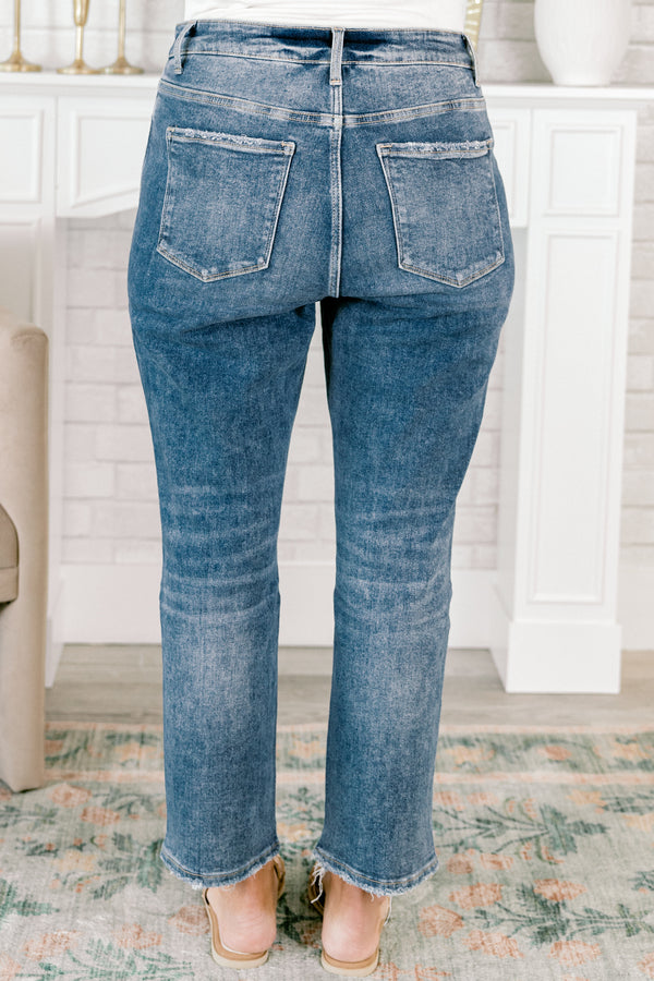 Chic Soul plus size clothing, medium wash denim jeans with distressed holes on the right pant leg and distressing and frayed hems