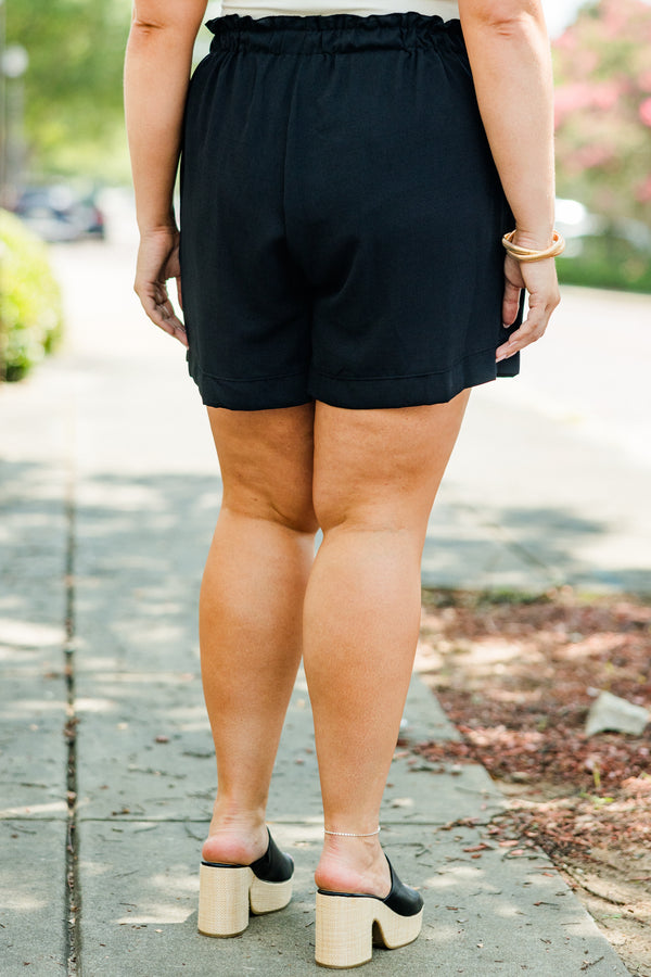 Plus Size black shorts with an elastic waistband, side pockets, and a relaxed fit.