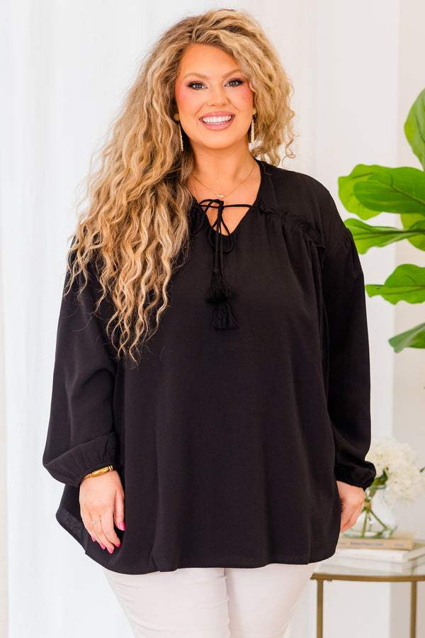 Plus Size black flowy top with long sleeves, a V-neckline, and a tassel tie detail.