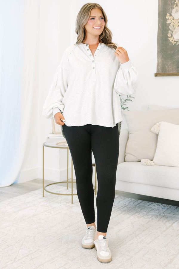 Plus Size high-waisted black active leggings in a smooth, matte polyester-spandex blend.