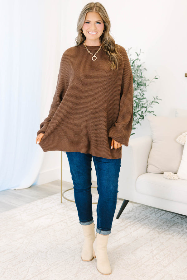 Plus size brown, oversized knit sweater with a crew neck and relaxed, flowy fit.