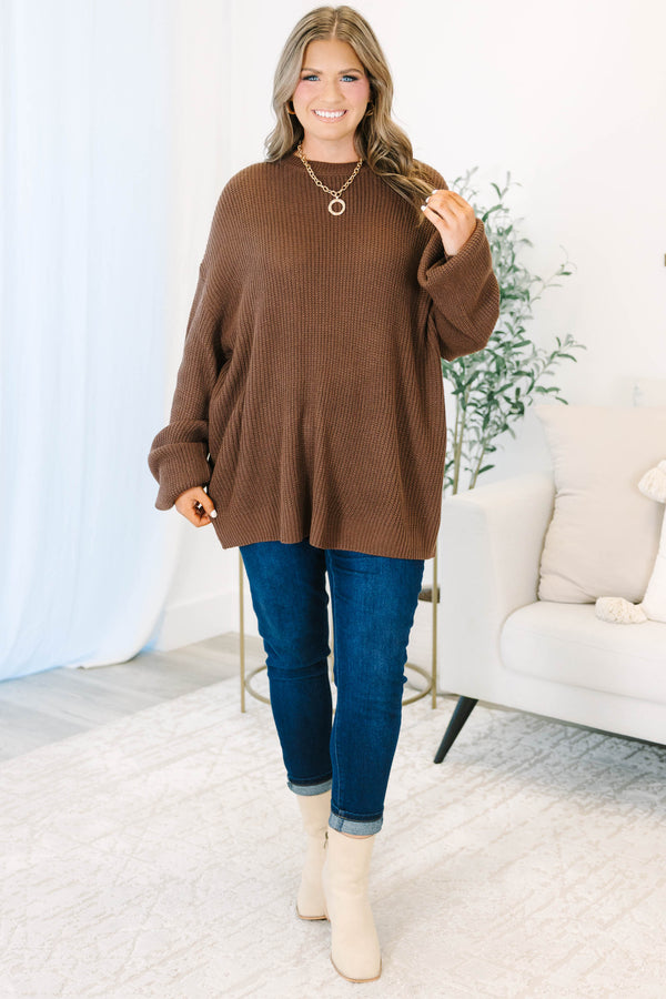 Plus size brown, oversized knit sweater with a crew neck and relaxed, flowy fit.