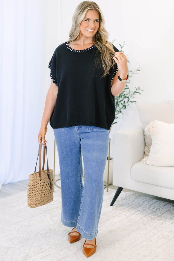 Plus Size black short sleeve knit top with white whipstitch detailing on the neckline and sleeves.