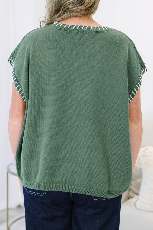 Plus Size green knit short sleeve top with white whipstitch detailing on the neckline and armholes.